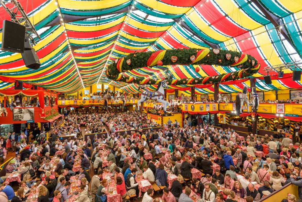 German beer festival in a traditional tent packed with people